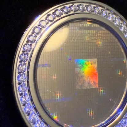 Close-up view of medallion with holographic surface